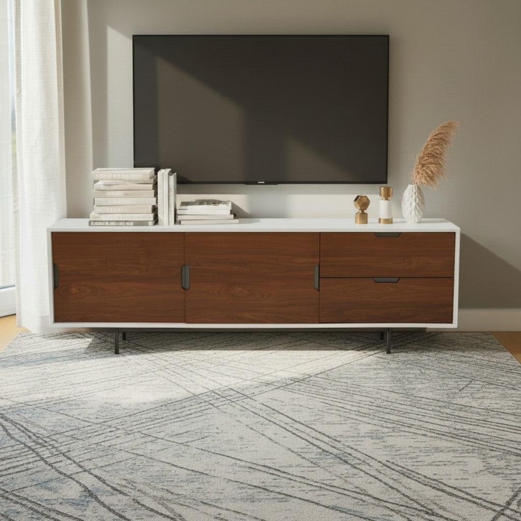 Homecrest Abbott solid wood media stand with a white frame and dark wood cabinet doors and drawers in a living room.