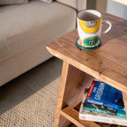 Homecrest Marlin acacia wood bedside table with a patterned mug and books on a shelf in a coastal style room