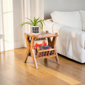 Homecrest handcrafted acacia wood Corbel side table with natural grain finish and a potted plant on top.