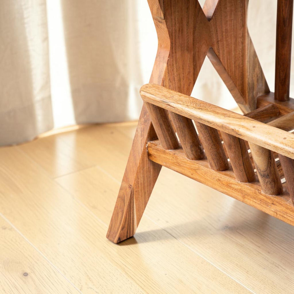Homecrest handcrafted acacia wood Corbel side table with visible natural wood grain in a tropical style room.