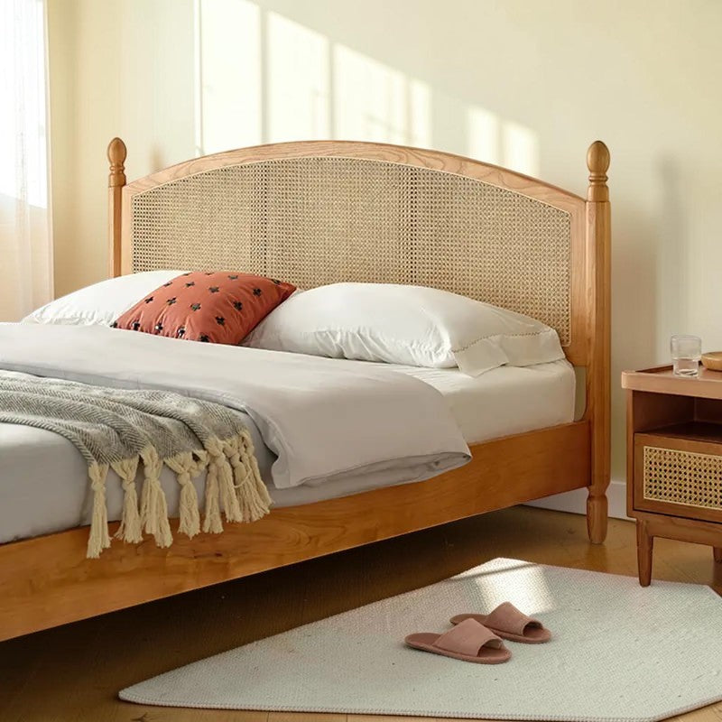 Homecrest mid-century style bed frame made of natural acacia wood with a woven rattan cane headboard in a bedroom