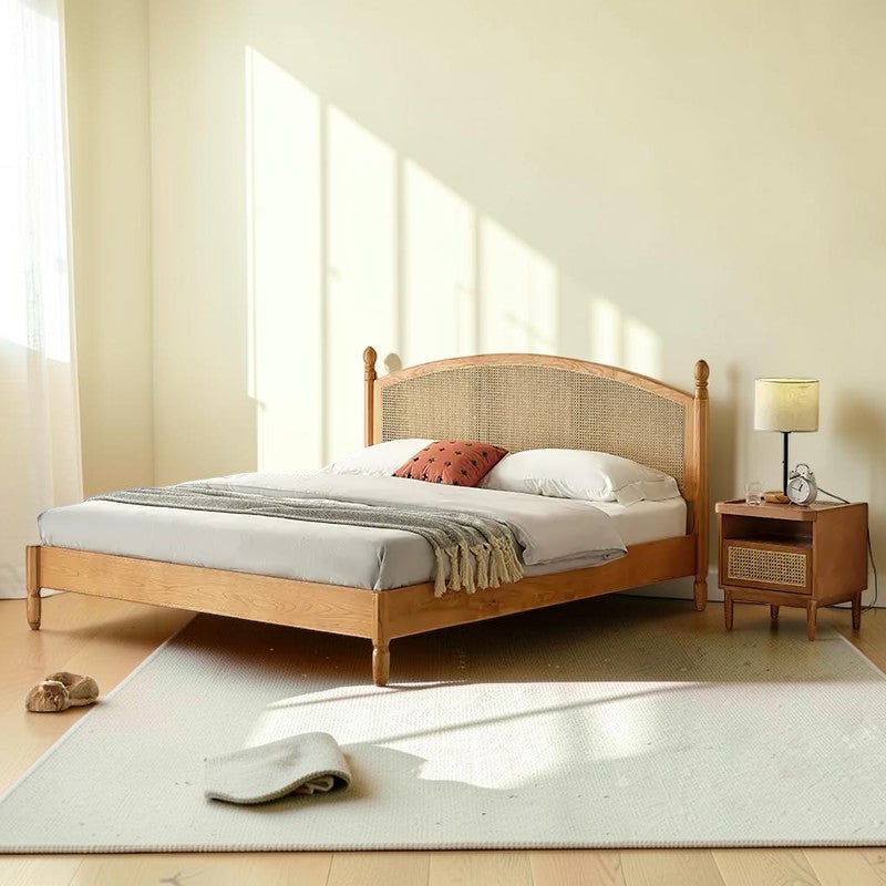 Homecrest mid-century style bed frame made of natural acacia wood with a woven rattan cane headboard in a bedroom.