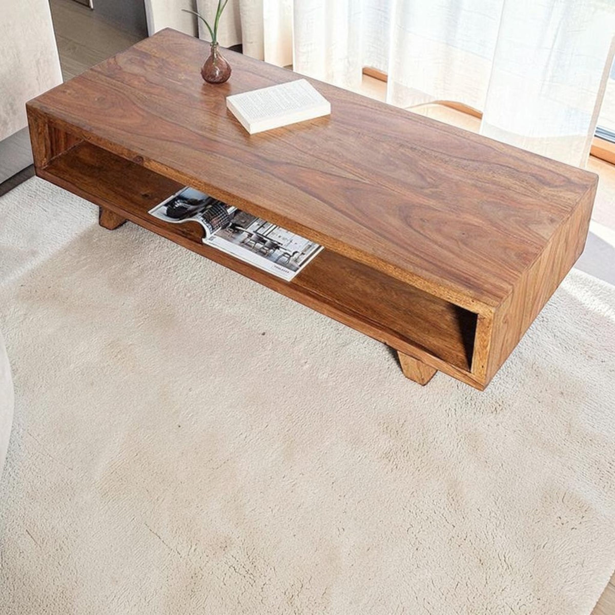 Homecrest Adler low rectangular coffee table in solid sheesham wood with an open storage cubby and tapered base.