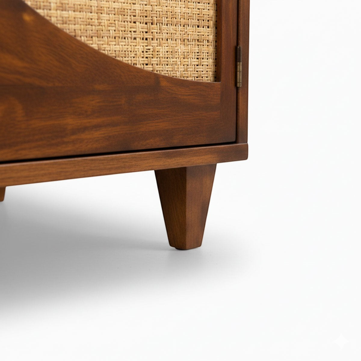 Close-up of the tapered wooden leg and honey-toned frame of the Homecrest Aldon media unit with cane webbing detail.