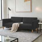 Homecrest Aldous black three-seater sofa bed with polyester upholstery and solid wood legs in a modern living room