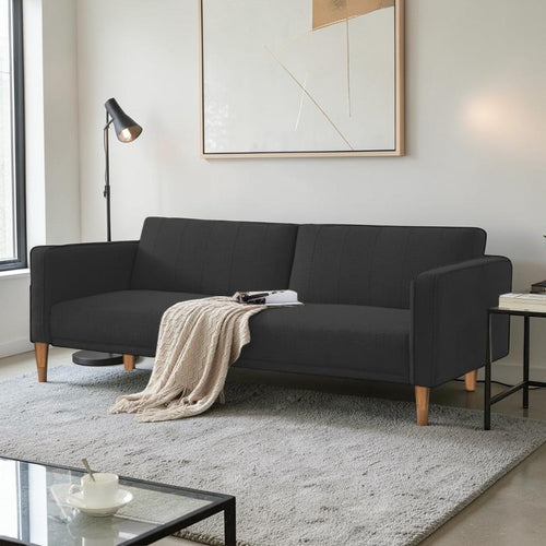 Homecrest Aldous black three-seater sofa bed with polyester upholstery and solid wood legs in a modern living room