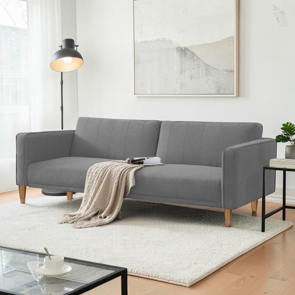 Homecrest Aldous light grey three-seater sofa bed with polyester upholstery and solid wood legs in a modern living room
