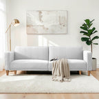 Homecrest Aldous light grey three-seater sofa bed with polyester upholstery and solid wood legs in a bright living room