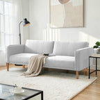 Homecrest Aldous light grey three-seater sofa bed with polyester upholstery and solid wood legs in a modern living room