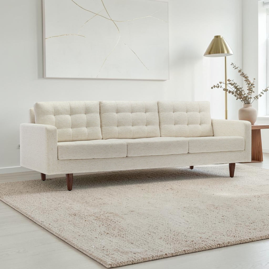 Homecrest Aldric contemporary three-seater sofa in bone fabric with tufted back cushions and slim teakwood legs.