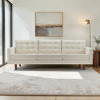 Homecrest Aldric contemporary three-seater sofa in bone fabric with slim teakwood legs in a bright living room
