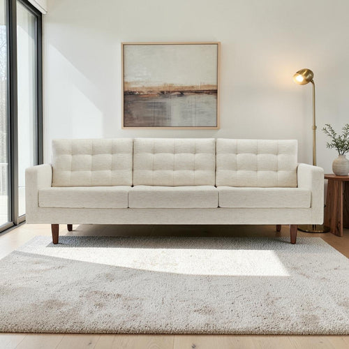 Homecrest Aldric contemporary three-seater sofa in bone fabric with slim teakwood legs in a bright living room