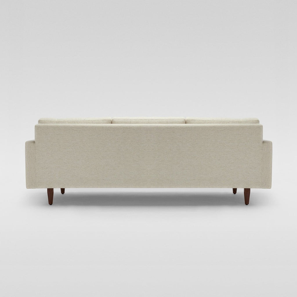 Homecrest Aldric contemporary sofa in bone fabric with slim teakwood legs, viewed from the back.