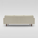 Homecrest Aldric contemporary sofa in bone fabric with slim teakwood legs, viewed from the back.