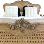 Homecrest Ancaster hand-carved mango wood bed featuring intricate floral carvings and natural rattan paneling