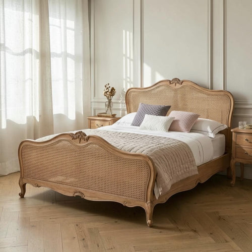 Homecrest Ancaster hand-carved natural mango wood bed with rattan detailing in a bright, elegant bedroom setting.