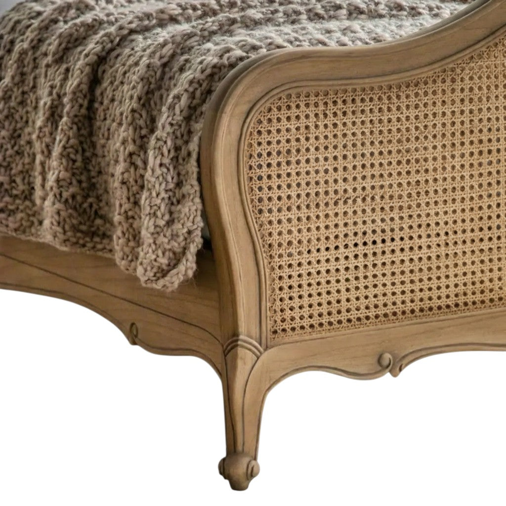 Homecrest Ancaster hand-carved natural wood bed frame with intricate rattan detailing and a cozy chunky knit throw