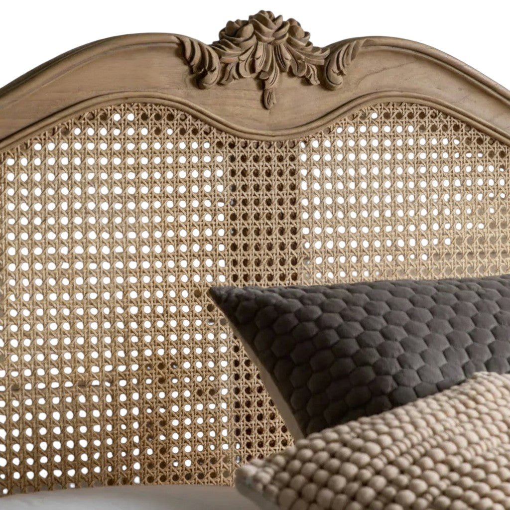 Homecrest Ancaster hand-carved mango wood bed headboard with natural rattan cane detailing and ornate floral carving.