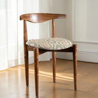 Homecrest Amberley mid-century dining chair made of natural teak wood with a patterned upholstered seat