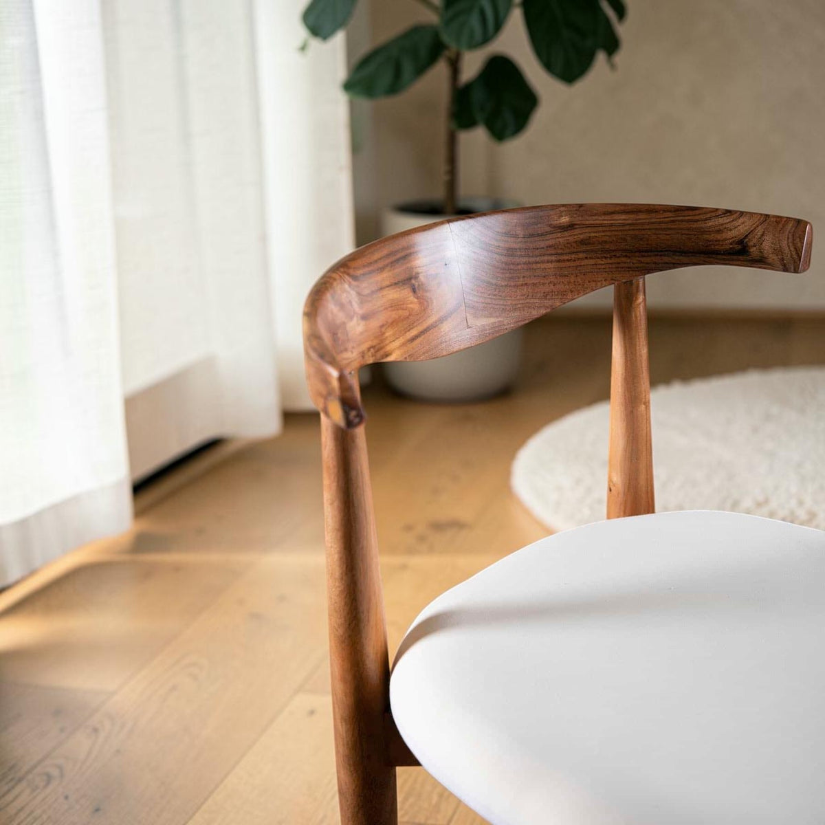 Homecrest Amberley mid-century dining chair with natural teak wood frame and white upholstered seat in a bright room