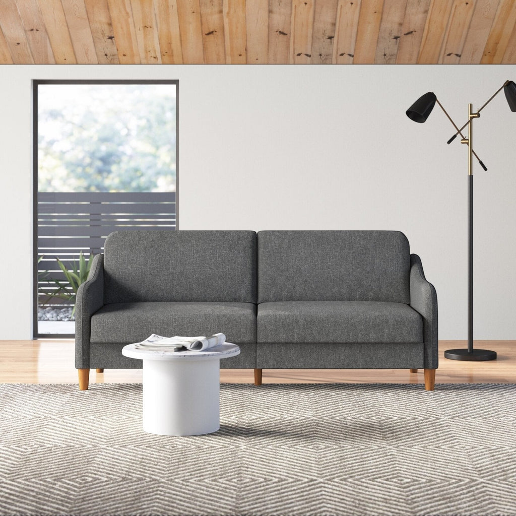 Homecrest Ashcroft three-seat sofa bed in dark grey polyester fabric with rounded arms and wooden legs in a living room