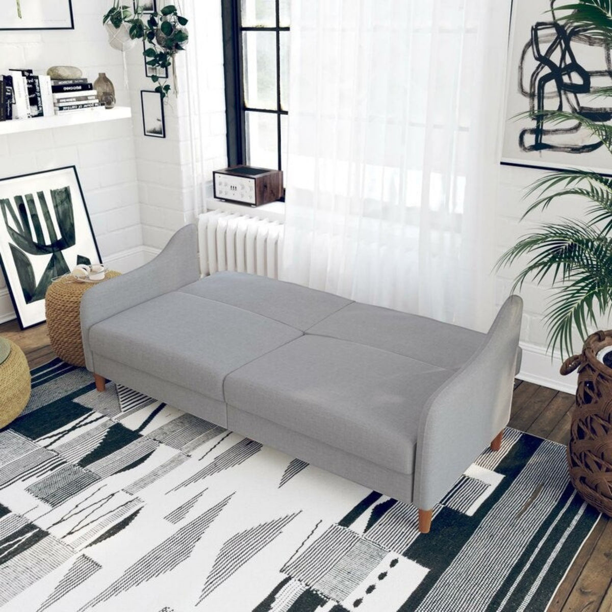 Homecrest Ashcroft light grey polyester sofa bed with rounded arms folded flat in a modern living room setting