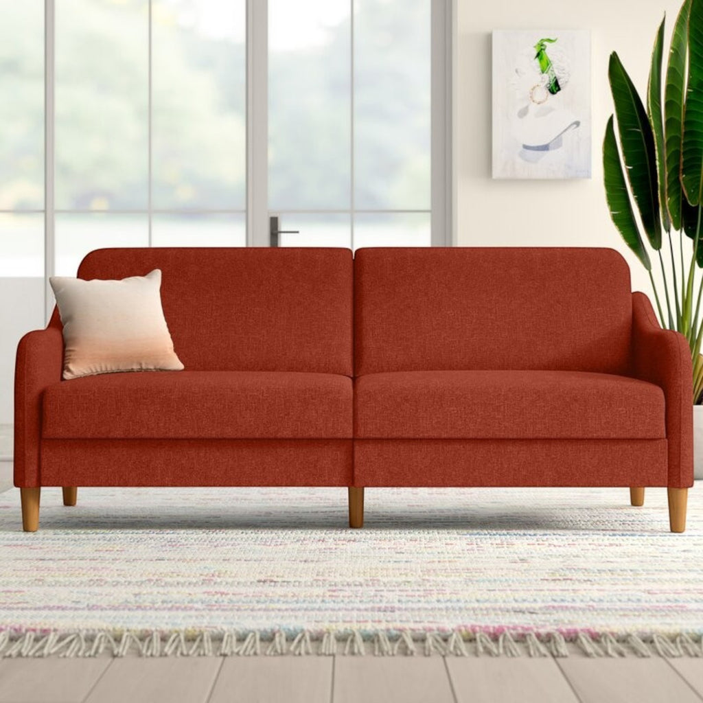 Homecrest Ashcroft three-seat sofa bed in red polyester fabric with rounded arms and wooden legs in a bright room