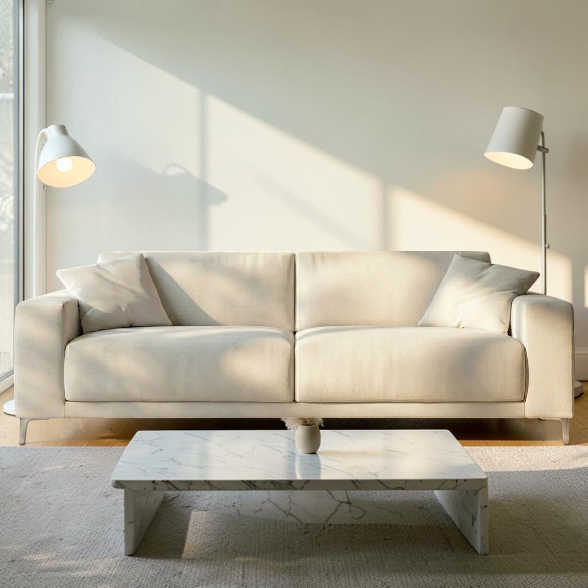 Homecrest Avebury three-seater sofa in off-white poly linen fabric with two matching throw pillows in a bright room.