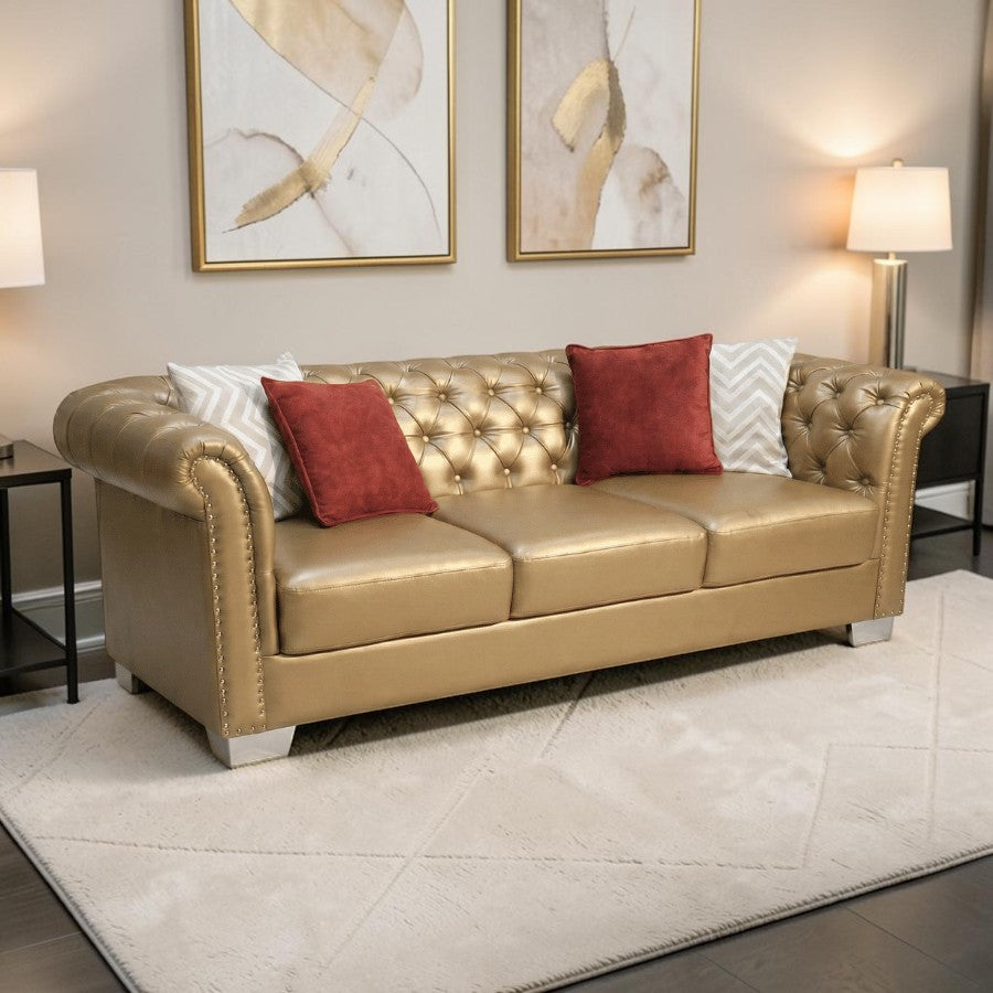 Homecrest Aurumite gold upholstered Chesterfield sofa with deep button tufting, rolled arms, and decorative pillows.