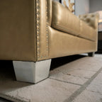 Homecrest Aurumite sofa featuring gold upholstery, nailhead trim, and modern silver metallic block feet.