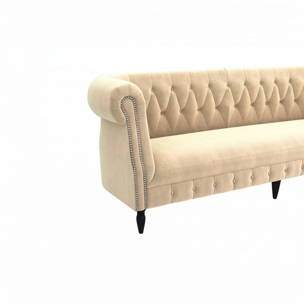 Homecrest Baslow Chesterfield sofa in beige velvet with tufted backrest, rolled arms, and silver nailhead trim.