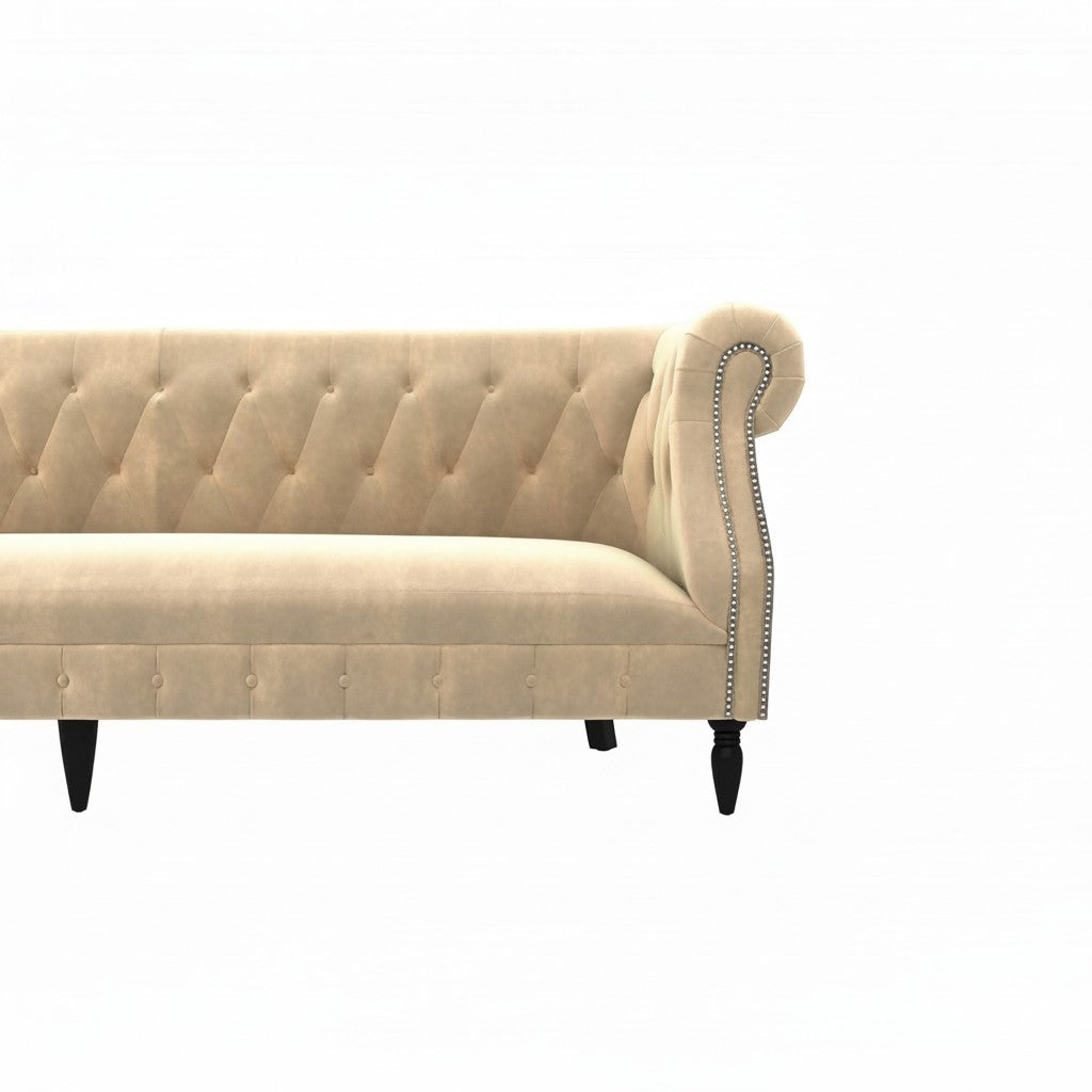 Homecrest Baslow Chesterfield sofa in beige velvet with tufted backrest, rolled arms, and silver nailhead trim.