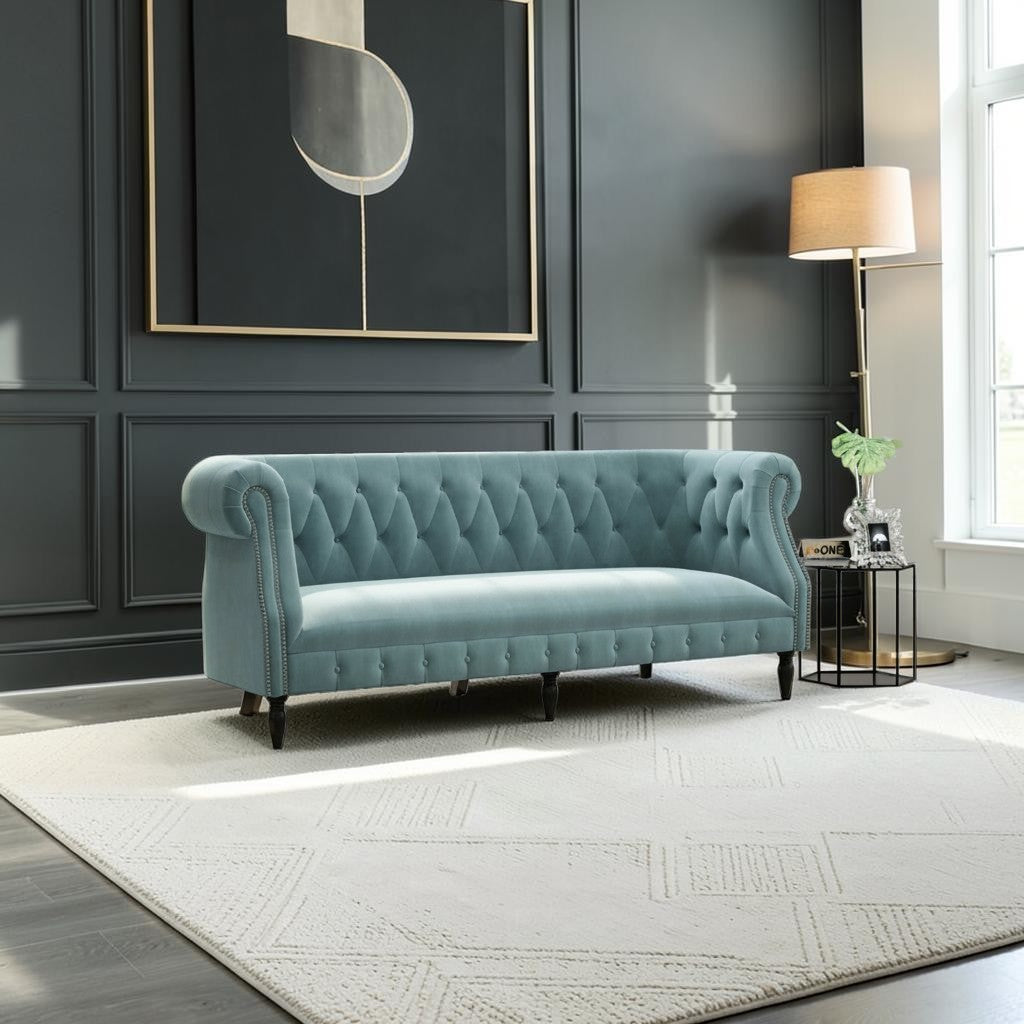 Homecrest Baslow Chesterfield sofa in dusk blue velvet with tufted back and nailhead trim in a modern living room