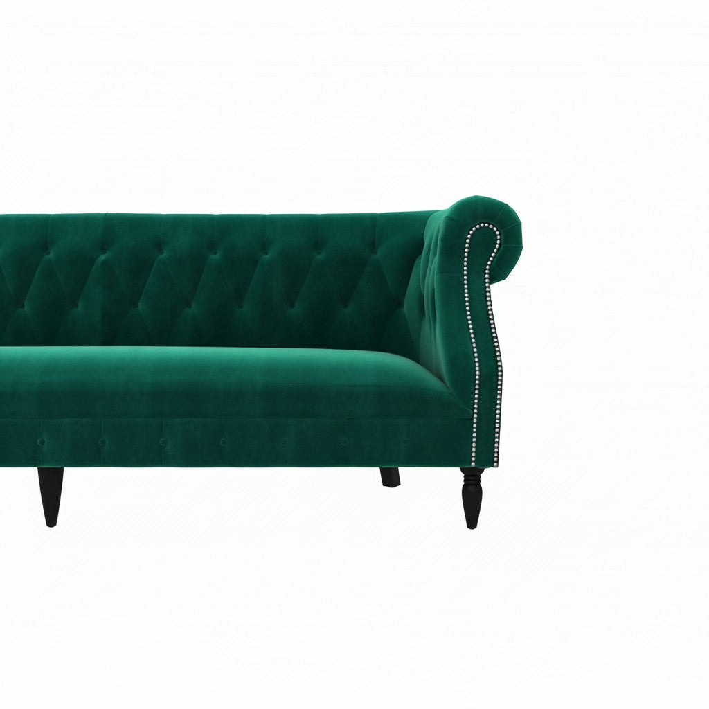Homecrest Baslow Chesterfield sofa in emerald green velvet with button tufting and silver nailhead trim on armrest