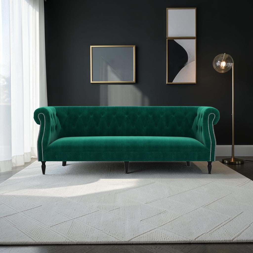Homecrest Baslow emerald green velvet Chesterfield sofa with tufted back and nailhead trim in a modern living room
