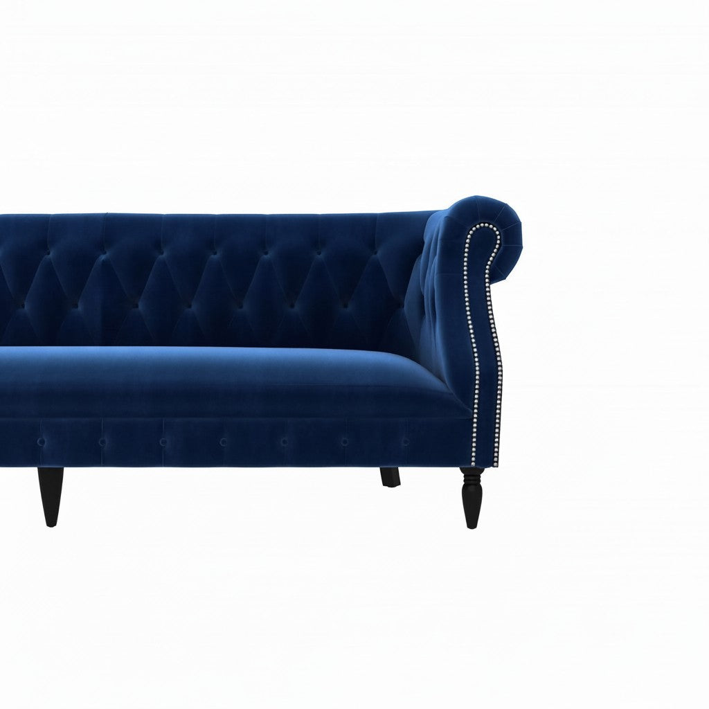 Homecrest Baslow Chesterfield sofa in indigo blue velvet with button tufting and silver nailhead trim on armrest