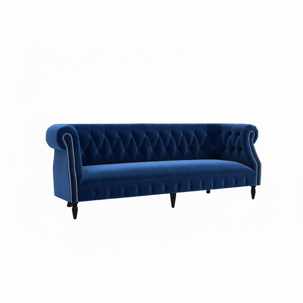 Homecrest Baslow three-seater Chesterfield sofa in indigo blue velvet with button tufting and silver nailhead trim.