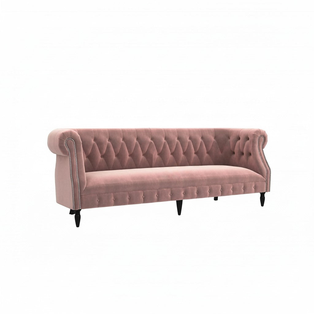 Homecrest Baslow rose dust velvet Chesterfield sofa with tufted backrest, rolled arms, and silver nailhead trim.