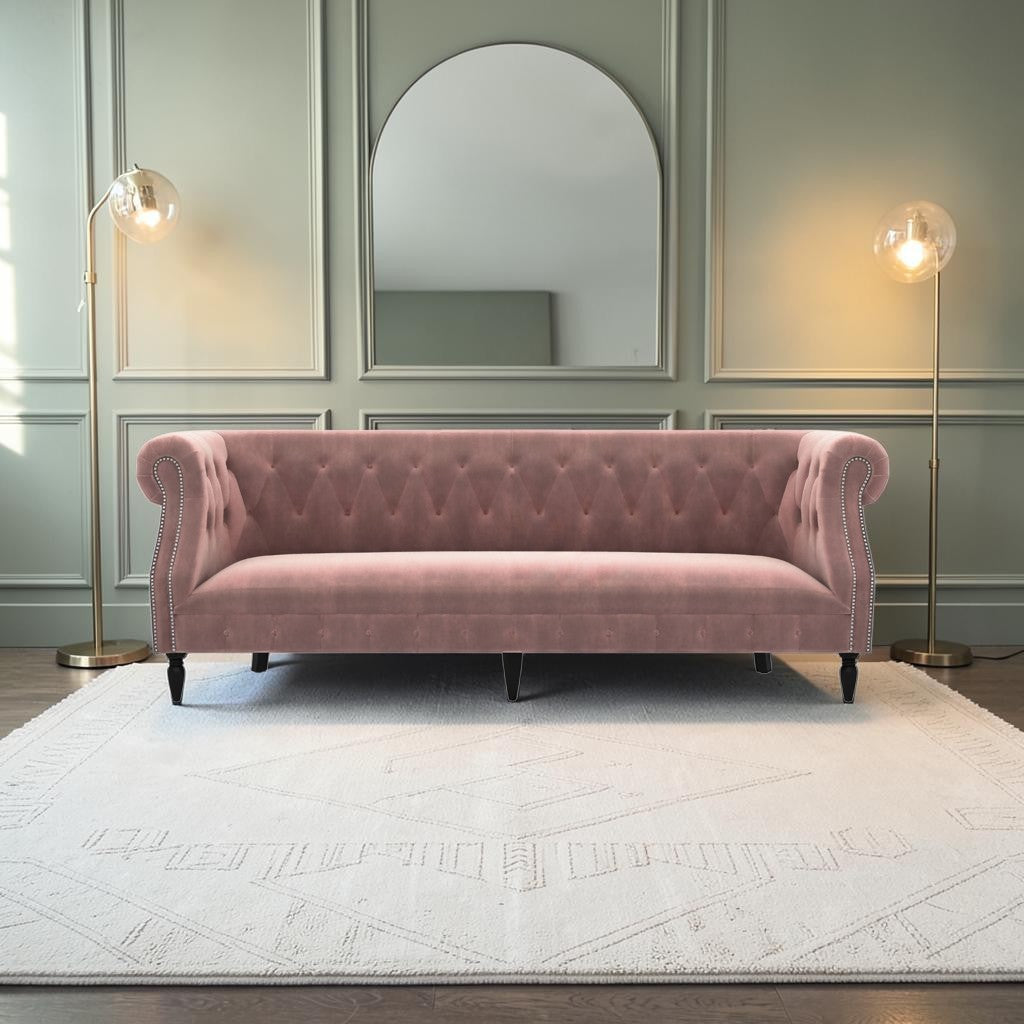 Homecrest Baslow Chesterfield sofa in rose dust velvet with tufted back and silver nailhead trim in a modern room.