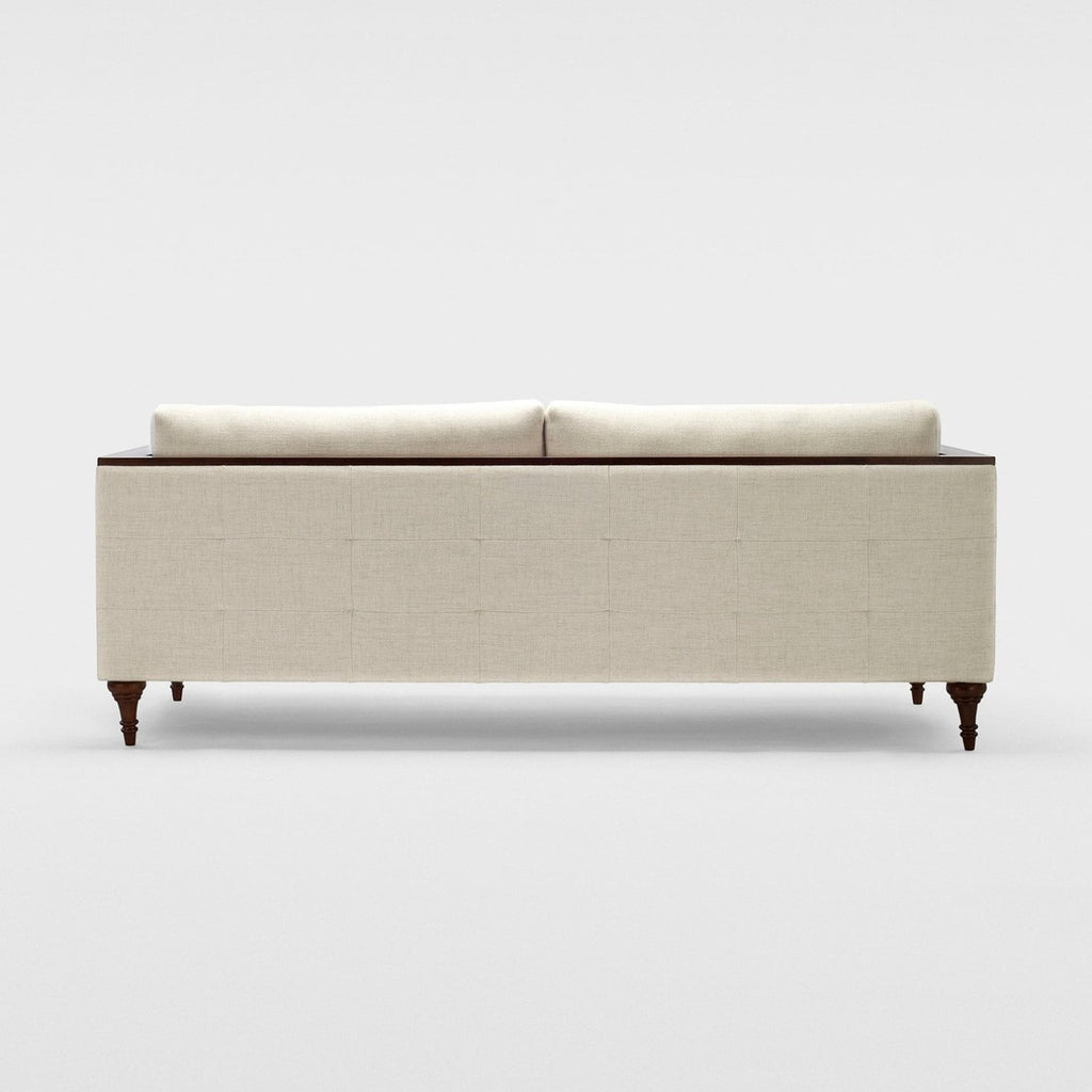 Homecrest Beaumont modern classic sofa in ivory fabric with a squared frame and dark turned teakwood legs, back view.