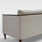 Homecrest Beaumont modern classic sofa in ivory fabric with dark wood turned legs and crisp veneer arm wrap detail.