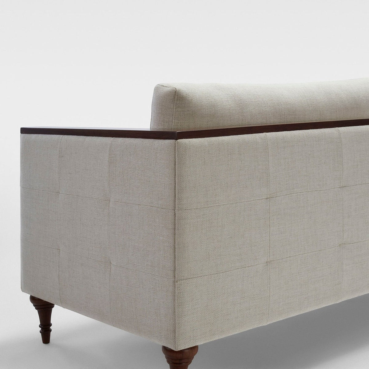 Homecrest Beaumont modern classic sofa in ivory fabric with dark wood turned legs and crisp veneer arm wrap detail.