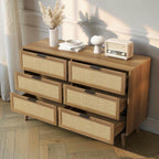 Homecrest Bexley six-drawer chest in natural acacia wood with woven rattan cane drawer fronts and black handles.