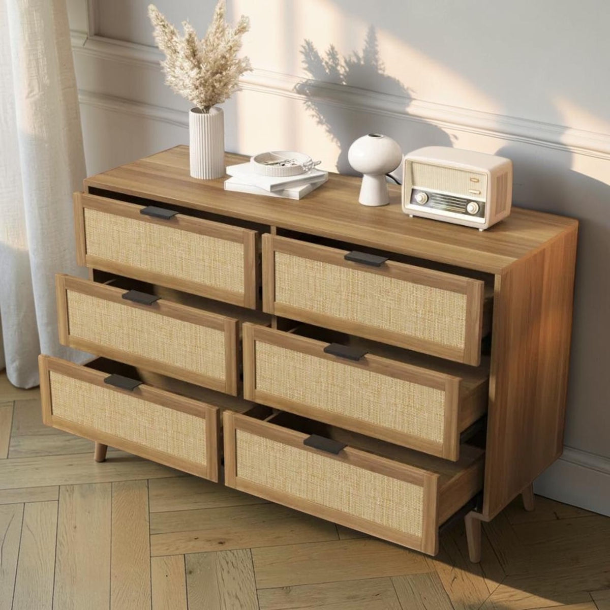 Homecrest Bexley six-drawer chest in natural acacia wood with woven rattan cane drawer fronts and black handles.
