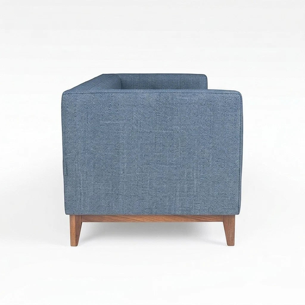Homecrest 3-seater sofa in blue fabric with a solid wood base and box arm design, side profile view.
