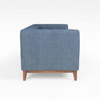 Homecrest 3-seater sofa in blue fabric with a solid wood base and box arm design, side profile view.