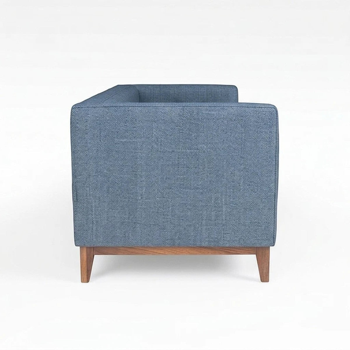 Homecrest 3-seater sofa in blue fabric with a solid wood base and box arm design, side profile view.