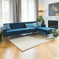 Homecrest mid-century blue velvet sectional sofa with chaise and teak wood legs in a modern living room setting