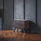 Homecrest Balcombe bedside table in solid dark hardwood with two drawers and brass knobs against a white brick wall