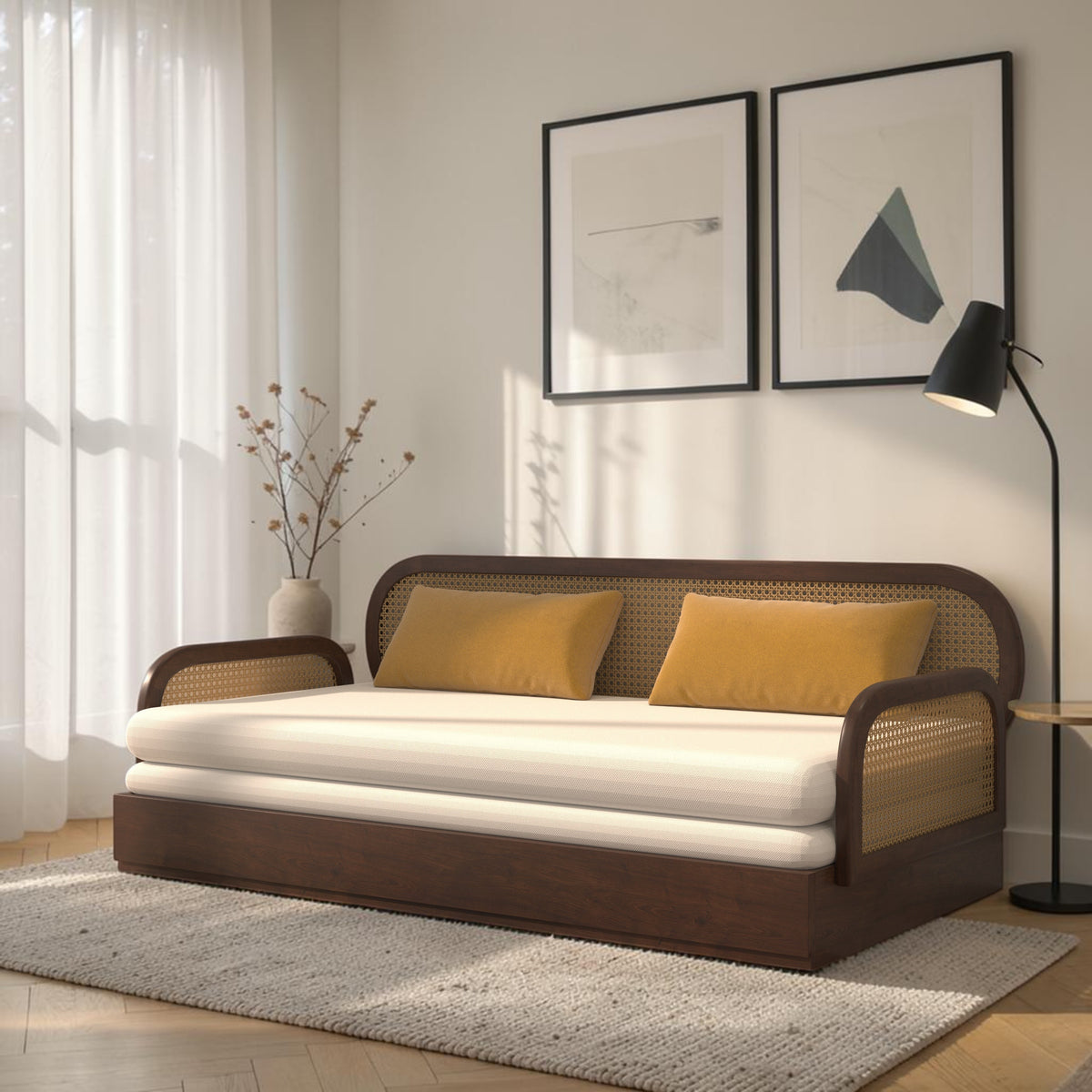 Homecrest Brayton acacia wood daybed with rounded cane-panel back and side rests, featuring cream cushions and pillows.